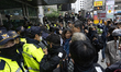 Hundreds of supporters of People Power Party presidential candidate Kim Moon-soo confront...
