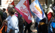 Flags of the SUD 'Public Finances' workers union are displayed. Hundreds of protesters mar...