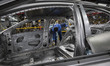 An Iranian laborer works on the production line at the Kerman Motor car factory in Kerman,...
