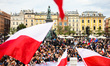 People hold flags while attending a campaign rally of Rafal Trzaskowski, the candidate of...