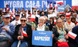 People hold flags while attending a campaign rally of Rafal Trzaskowski, the candidate of...