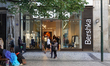 People walk by the entrance of the Bershka clothing store in central Prague, Czech Republi...