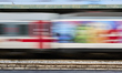 A multicolored Trenitalia regional train arrives at or departs from Bari Centrale railway...