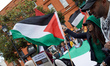 People react during the reading of the names of Gazans killed by Israel. A commemoration o...