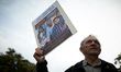 A protester holds a placard reading 'Gaza: Figures, not only numbers'. A commemoration of...