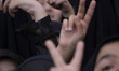 Iranian schoolgirls make heart-shaped hand gestures and flash Victory signs while particip...