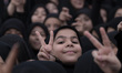 Iranian schoolgirls flash Victory signs while participating in a ceremony commemorating th...