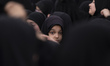 An Iranian schoolgirl looks on while participating in a ceremony commemorating the late Ir...