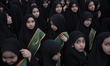 Iranian schoolgirls look on while participating in a ceremony commemorating the late Irani...