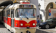 A tram of line 22 emerges from a narrow arched passageway in the historic district of Prag...