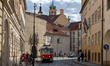 Historic tram line 23 passes through a narrow cobblestone street in the old town district...