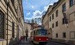 Historic tram line 23 passes through a narrow cobblestone street in the old town district...