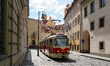 Tram line 12 operates through a historic cobblestone street in the old town district of Pr...