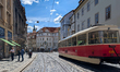 Tram line 12 operates through a historic cobblestone street in the old town district of Pr...