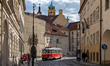 Historic tram line 23 passes through a narrow cobblestone street in the old town district...