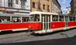 Two red and cream-colored trams, including a Tatra T3 model of line 22, travel through the...