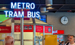 A public transport information point shows directions for metro, tram, and bus services at...
