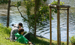 Two boys sit on the grass by the Vltava River in Prague, Czech Republic, on May 12, 2025....
