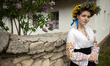 A woman in a floral crown wears a vyshyvanka, a Ukrainian embroidered shirt featuring orne...