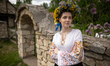 A woman in a floral crown wears a vyshyvanka, a Ukrainian embroidered shirt featuring orne...