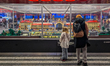 A child and an adult observe a large model railroad display of Prague Central Station in t...