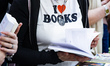 A woman with a t-shirt reading 'I love books' visits the Salone del Libro (Book Fair) 2025...