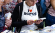 A woman with a t-shirt reading 'I love books' visits the Salone del Libro (Book Fair) 2025...