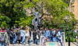 Tourists with a guide stand at the Franz Kafka statue by Jaroslav Rona between the Church...