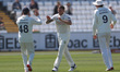 Brydon Carse celebrates with Colin Ackerman after dismissing Jack Haynes during the first...