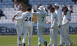Brydon Carse celebrates with his teammates after dismissing Jack Haynes during the first d...