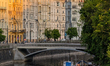Paddle boats dock along the Vltava River near the historic Art Nouveau buildings of Prague...
