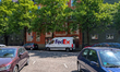 A Federal Express (FedEx) delivery van parks in front of a residential building in Munich,...