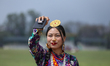 A female member of Nepal's indigenous Kirat community takes a selfie as she attends a mass...