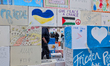A view through a window in the symbolic peace wall, made of hand-painted messages and draw...