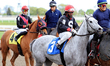 Jockey Juan Crawford rides Worry Less in front of jockey Leo Salles on Poetic Amy in the p...