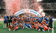 Olympiacos players and team personnel celebrate with the trophy following the Greek Cup Fi...