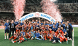 Olympiacos players and team personnel celebrate with the trophy following the Greek Cup Fi...