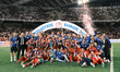 Olympiacos players and team personnel celebrate with the trophy following the Greek Cup Fi...