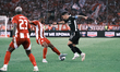 Olympiacos' Ayoub El Kaabi (center) is challenged by OFI's Juan Neira during the Greek Cup...