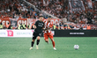 Olympiacos' Chiquinho (right) is challenged by OFI's Borja Gonzalez (left) during the Gree...