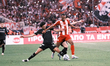 OFI's Jordan Silva (left) is challenged by Olympiacos' Ayoub El Kaabi (right) during the G...