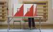A person votes at a polling station during presidential elections in Warsaw, Poland, on Ma...