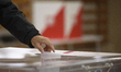 A man casts his ballot at a polling station during presidential elections in Warsaw, Polan...