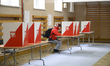 A woman votes at a polling station during presidential elections in Warsaw, Poland, on May...