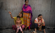 Slum dwellers break down in tears after their homes are destroyed in a fire in Dhaka, Bang...