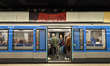 A metro train with open doors is at Koenigsplatz underground station as passengers board a...