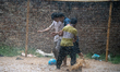 Boys play football during heavy rainfall in a residential area in Dhaka, Bangladesh, on Ma...