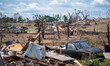 Damage is visible after an EF-4 tornado carves a 16-mile path of destruction through Laure...