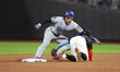 Los Angeles Dodgers' Shohei Ohtani #17 is thrown out at second base as Mets' second basema...