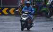 A man rides a scooter during rain in Nagaon district, Assam, India, on May 30, 2025. 